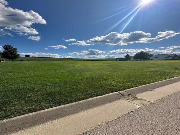 a view of a big yard with table & chairs
