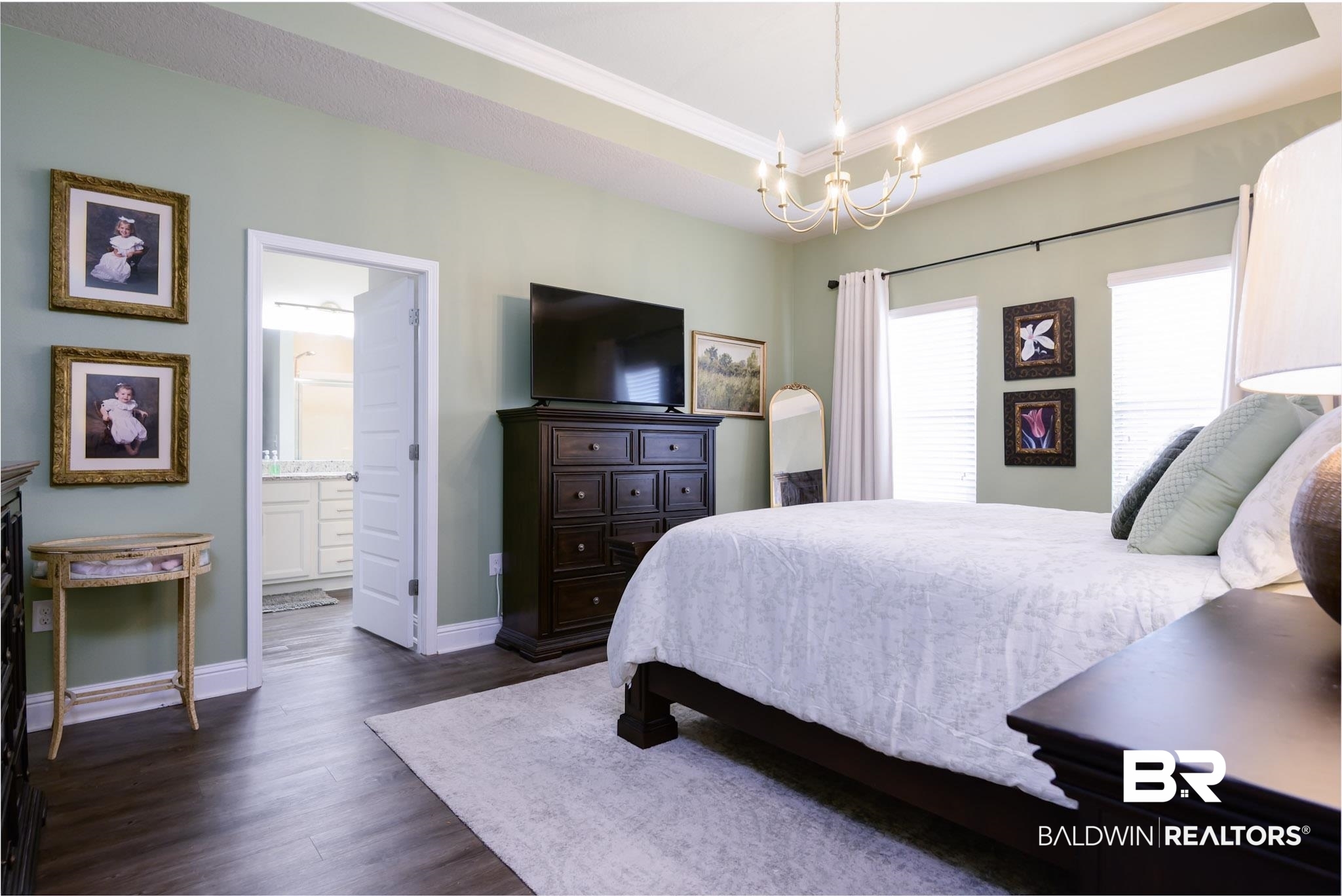 31751 Kestrel Loop Daphne, AL 36527 - Photo 14 of 21 Bedroom with dark wood-type flooring, a tray ceiling, hanging lights, and ornamental molding