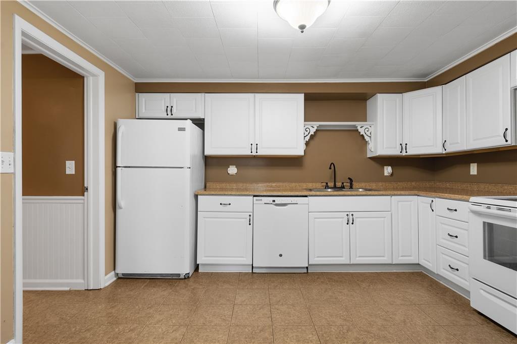 401 Upper Road Pittsburgh, PA 15228 - Photo 8 of 32 a kitchen with cabinets appliances and a refrigerator