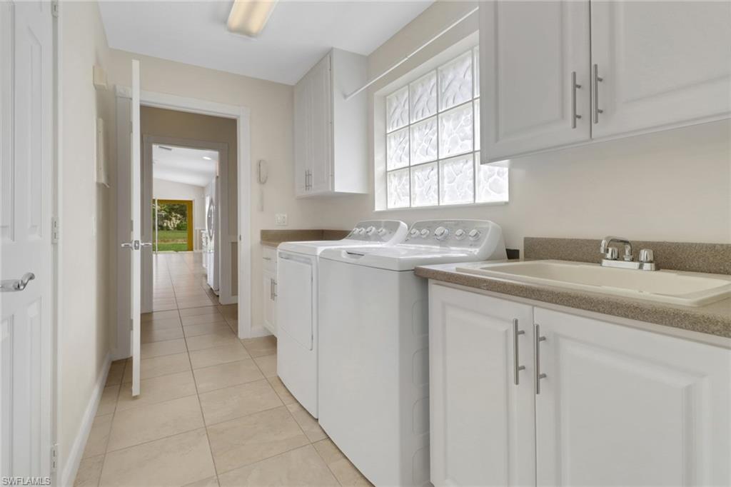 7933 Umberto Court Naples, FL 34114 - Photo 15 of 17 a kitchen with a sink cabinets appliances and a window