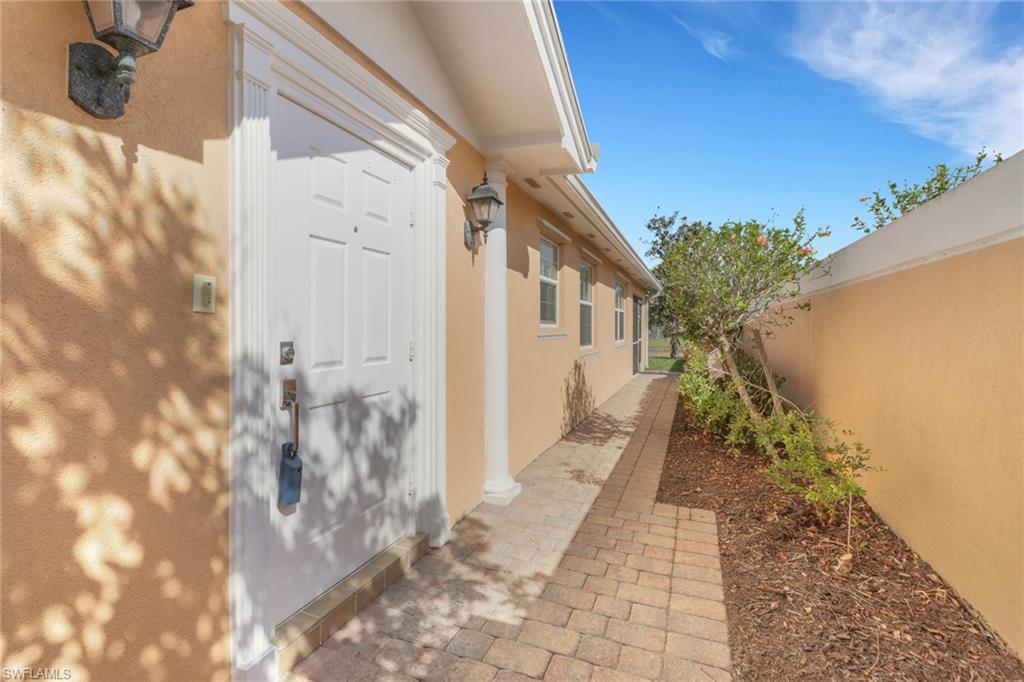 7933 Umberto Court Naples, FL 34114 - Photo 2 of 17 a view of a pathway with a yard