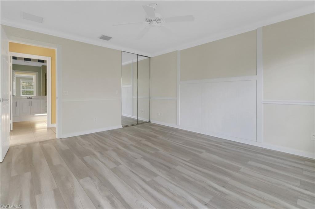 7933 Umberto Court Naples, FL 34114 - Photo 8 of 17 a view of an empty room and wooden floor