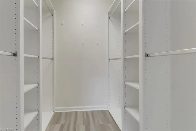 a view of an empty room and wooden floor