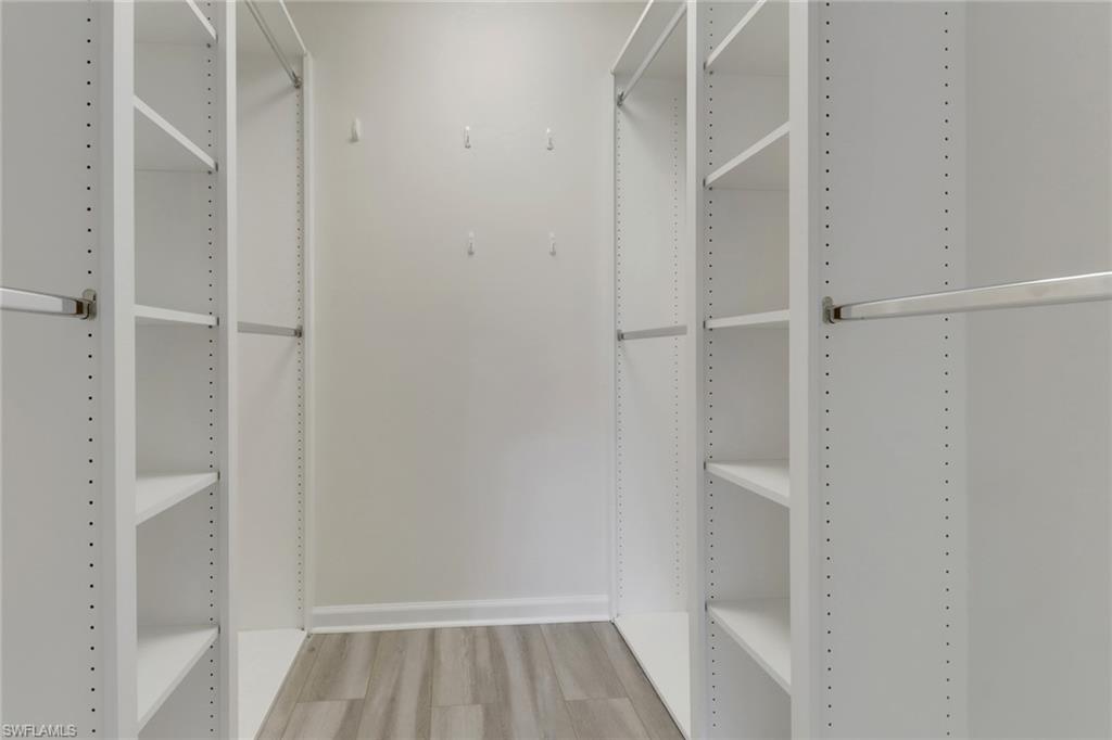 7933 Umberto Court Naples, FL 34114 - Photo 9 of 17 a view of walk in closet with empty racks
