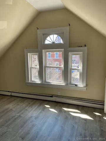 a view of a livingroom with wooden floor and a window