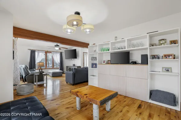 a kitchen with stainless steel appliances a sink cabinets and wooden floor