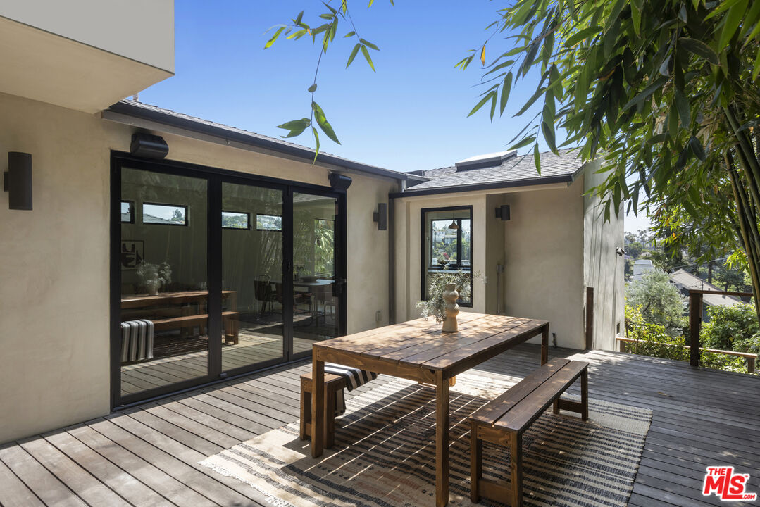 1508 Elevado Street Los Angeles, CA 90026 - Photo 12 of 50 a view of a patio with table and chairs and wooden floor