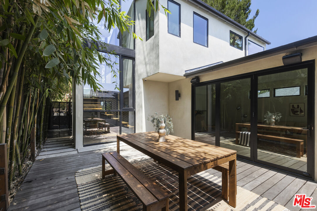 1508 Elevado Street Los Angeles, CA 90026 - Photo 14 of 50 a view of a patio with table and chairs and wooden floor
