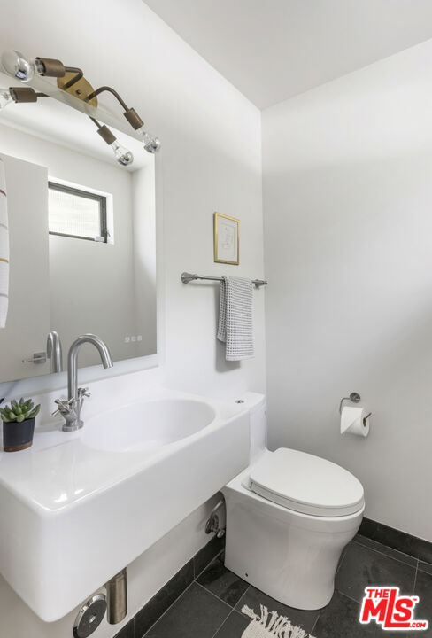 1508 Elevado Street Los Angeles, CA 90026 - Photo 25 of 50 a bathroom with a sink a toilet and mirror