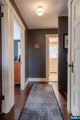 a view of hallway with wooden floor