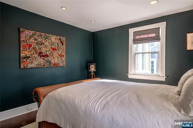 a bedroom with a large bed and a window