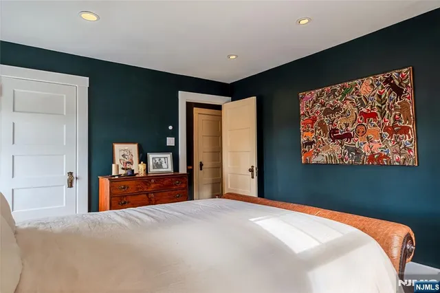 a bedroom with a bed and dresser