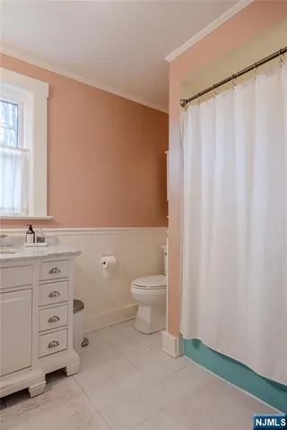 a bathroom with a granite countertop sink toilet and a mirror