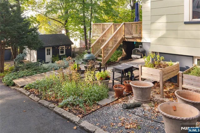 a backyard of a house with table and chairs