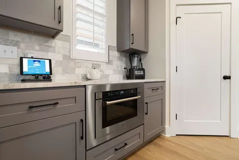 a kitchen with stainless steel appliances granite countertop a sink a stove and a wooden floors
