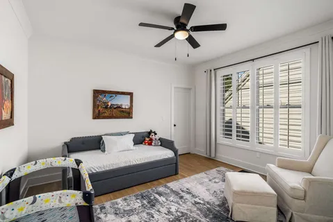a bedroom with a bed couch and window