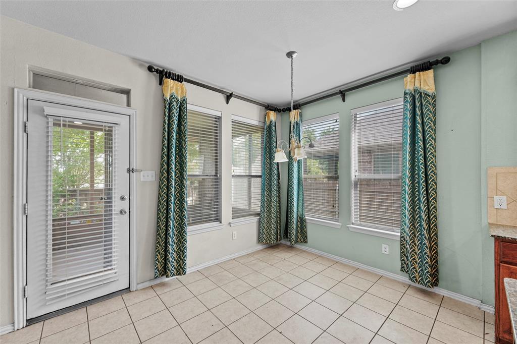 2405 Reston Drive McKinney, TX 75072 - Photo 15 of 38 Unfurnished dining area featuring a chandelier and light tile patterned floors