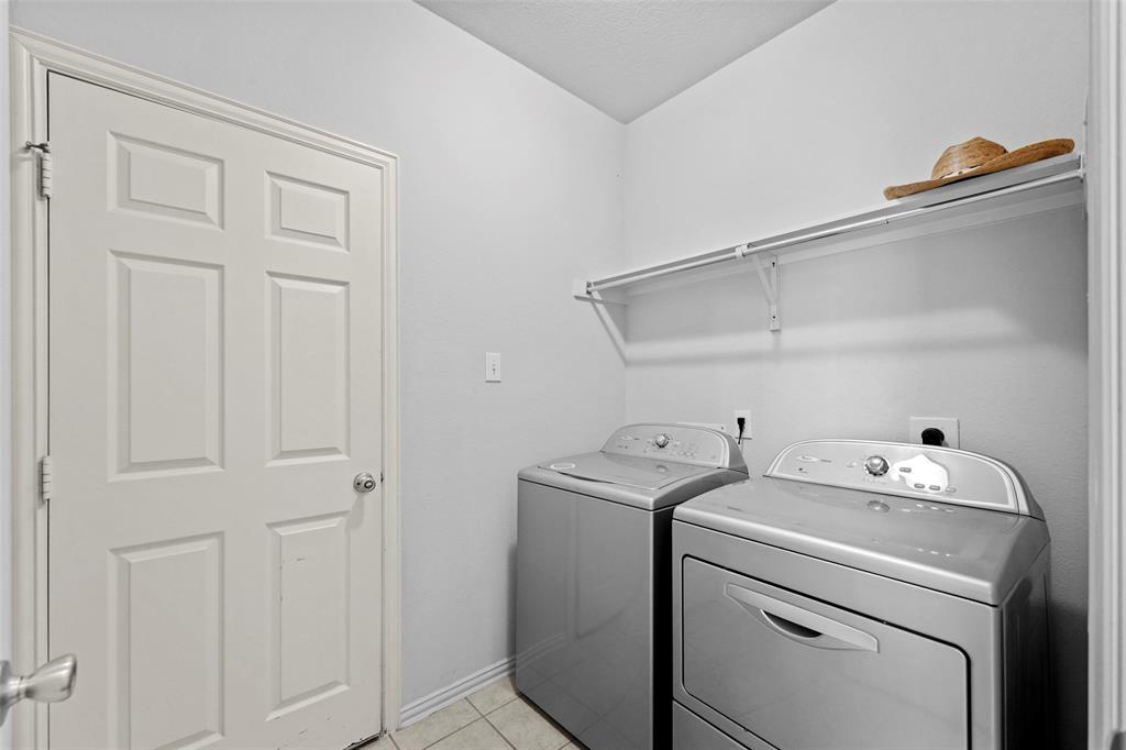 2405 Reston Drive McKinney, TX 75072 - Photo 17 of 38 Laundry area with washing machine and clothes dryer and light tile patterned flooring