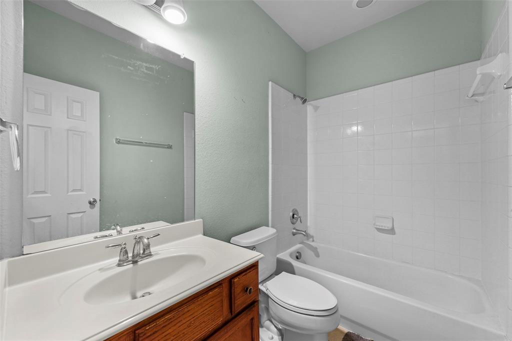 2405 Reston Drive McKinney, TX 75072 - Photo 18 of 38 Full bath featuring vanity, bathtub / shower combination, and a textured wall