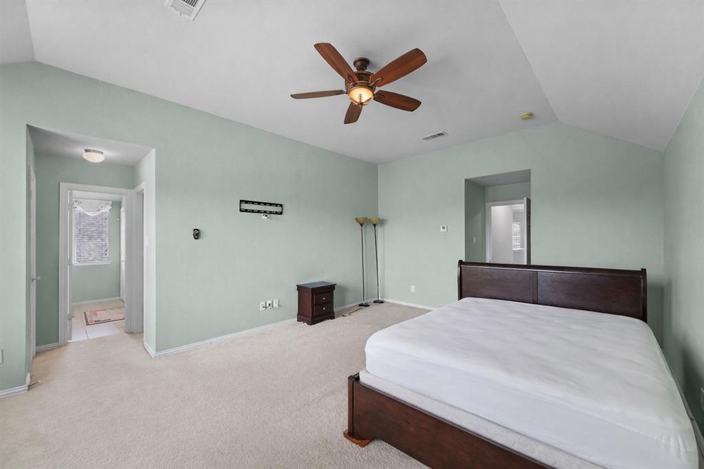 2405 Reston Drive McKinney, TX 75072 - Photo 24 of 38 Spacious room featuring vaulted ceilings, light green walls, and carpeted flooring