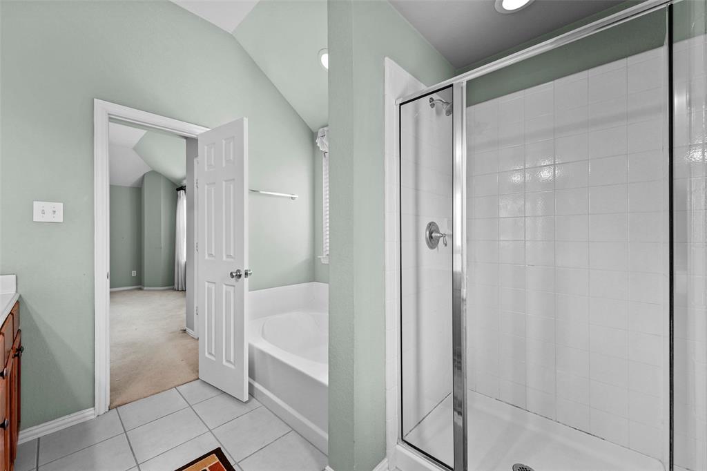 2405 Reston Drive McKinney, TX 75072 - Photo 27 of 38 Full bath with vanity, a bath, a shower stall, light carpet, and light tile patterned floors