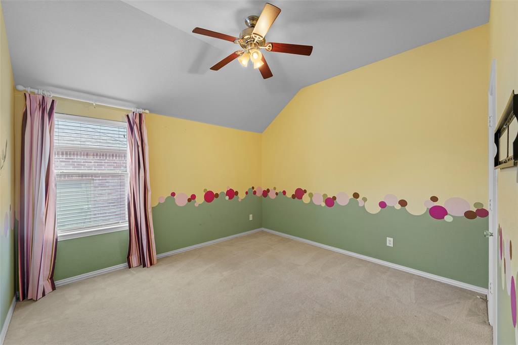 2405 Reston Drive McKinney, TX 75072 - Photo 29 of 38 Empty room featuring lofted ceiling, light carpet, and a ceiling fan