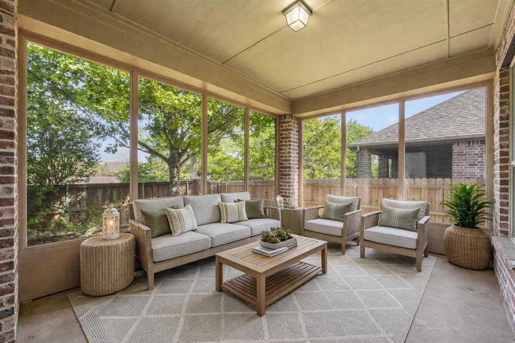 2405 Reston Drive McKinney, TX 75072 - Photo 31 of 38 This screened porch features brick columns, an overhead light fixture, and a patterned area rug