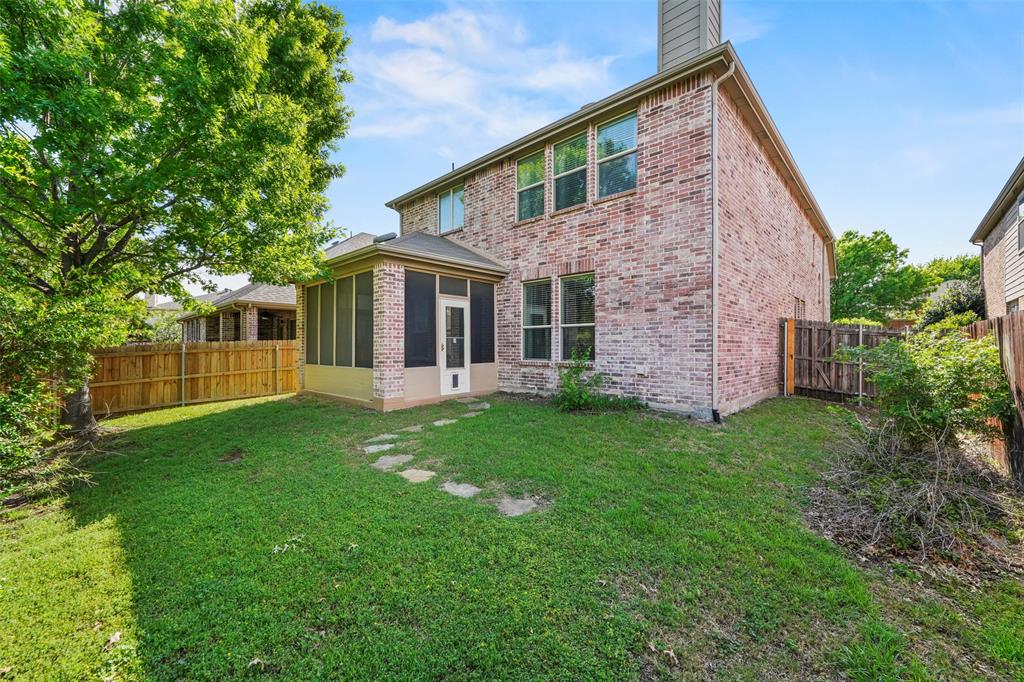 2405 Reston Drive McKinney, TX 75072 - Photo 34 of 38 Rear view of property featuring a sunroom, brick siding, a fenced backyard, and a chimney