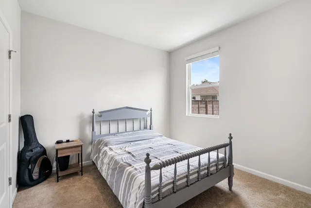 a bedroom with a bed and a television