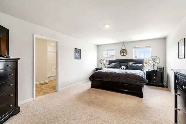 a bedroom with a bed and a night stand