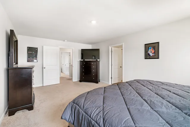 a bathroom with a granite countertop sink a toilet and shower