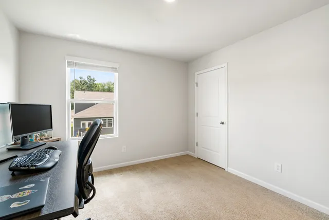 a view of an empty room with furniture and storage