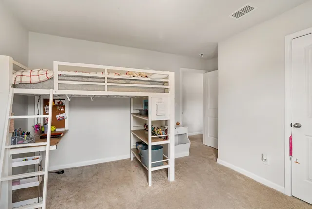 a bedroom with bed and a chandelier