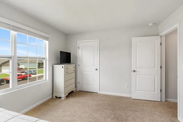 a backyard of a house with table and chairs