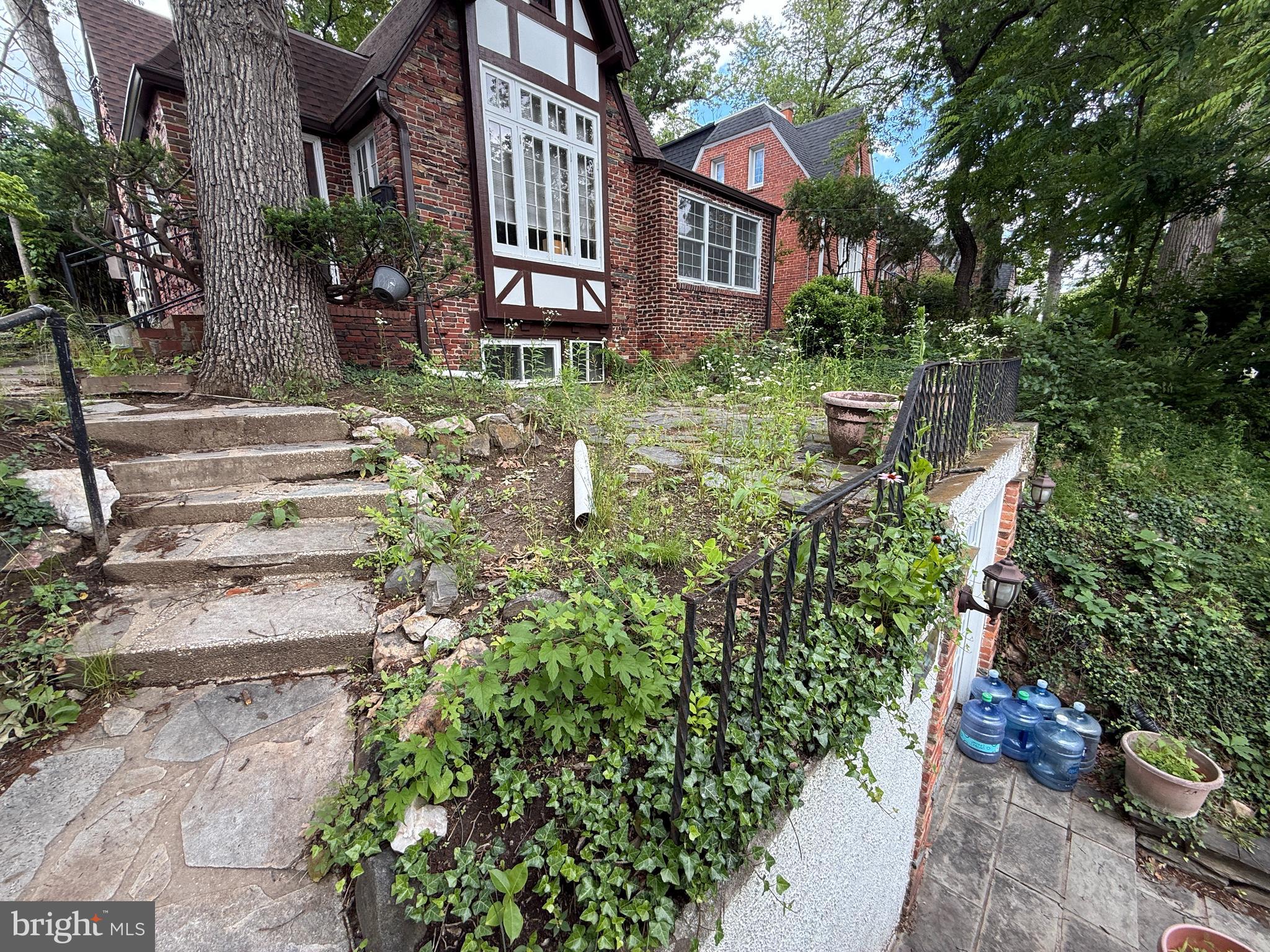 a front view of a house with a yard and fountain