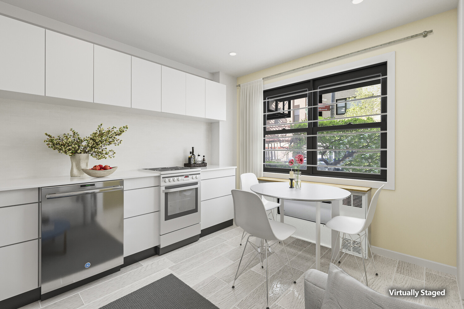 a kitchen with stainless steel appliances a white table chair and a window