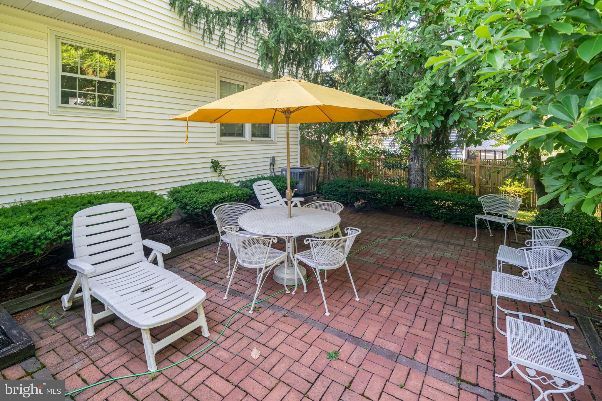 13 Madison Drive Clementon, NJ 08021 - Photo 25 of 36 a view of a patio with a table and chairs under an umbrella