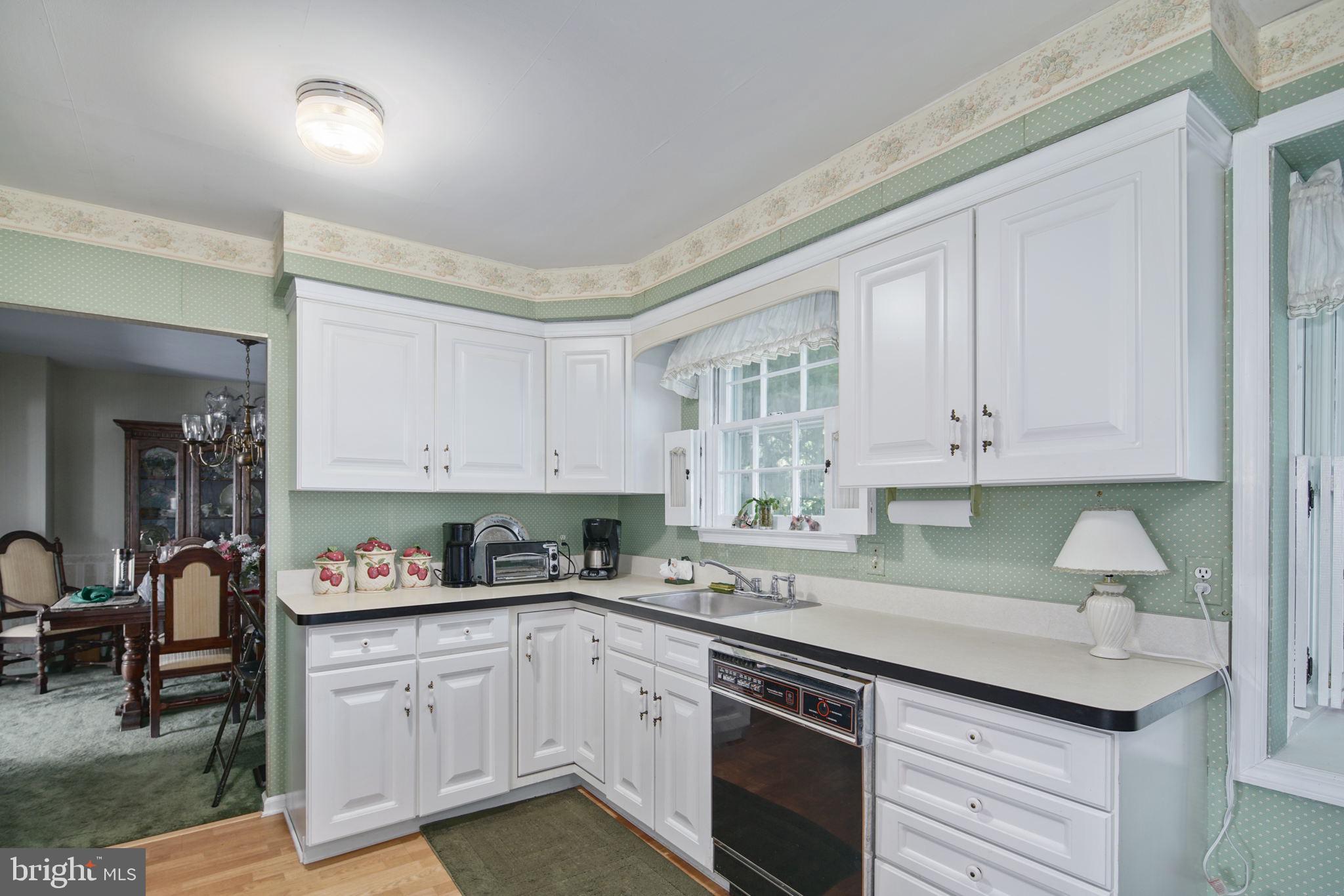 13 Madison Drive Clementon, NJ 08021 - Photo 8 of 36 a kitchen with granite countertop white cabinets and white appliances