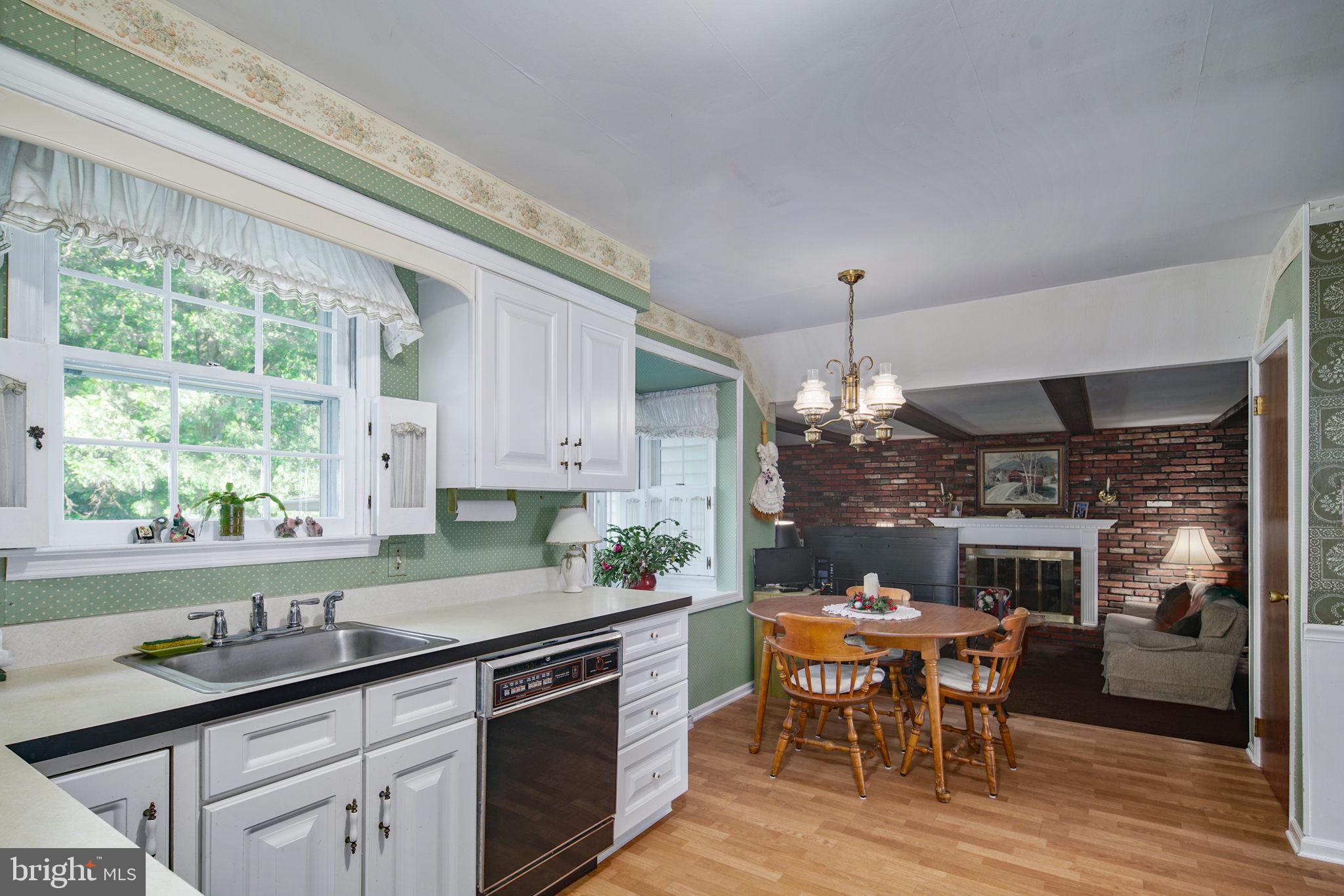 13 Madison Drive Clementon, NJ 08021 - Photo 9 of 36 a kitchen with a table chairs and a window