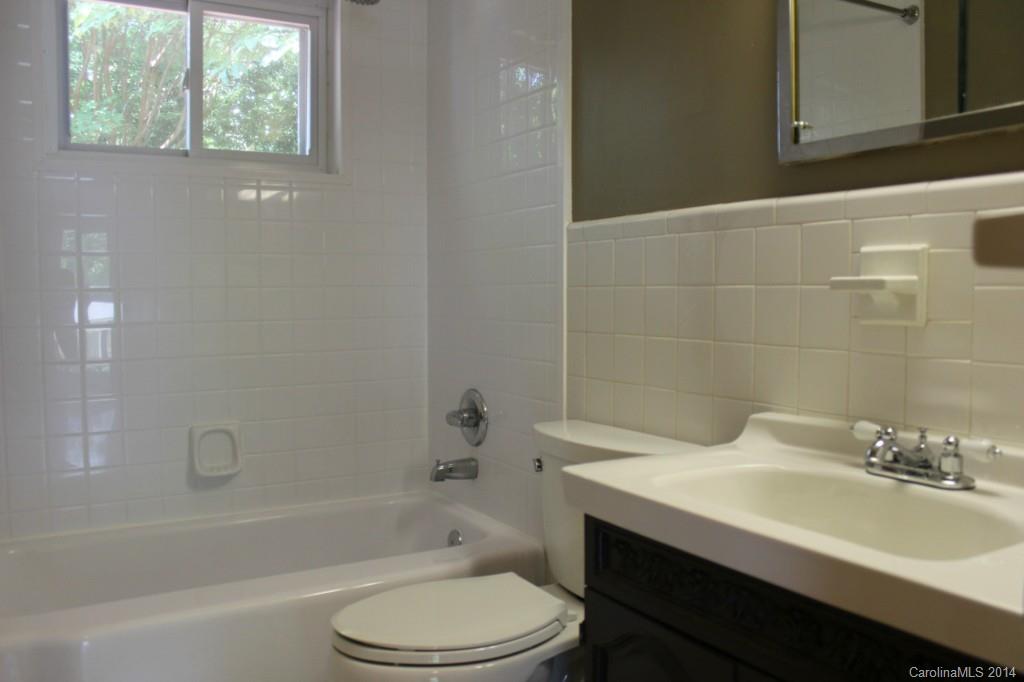 1510 Burnley Road Charlotte, NC 28210 - Photo 12 of 19 a bathroom with a sink toilet vanity and bathtub