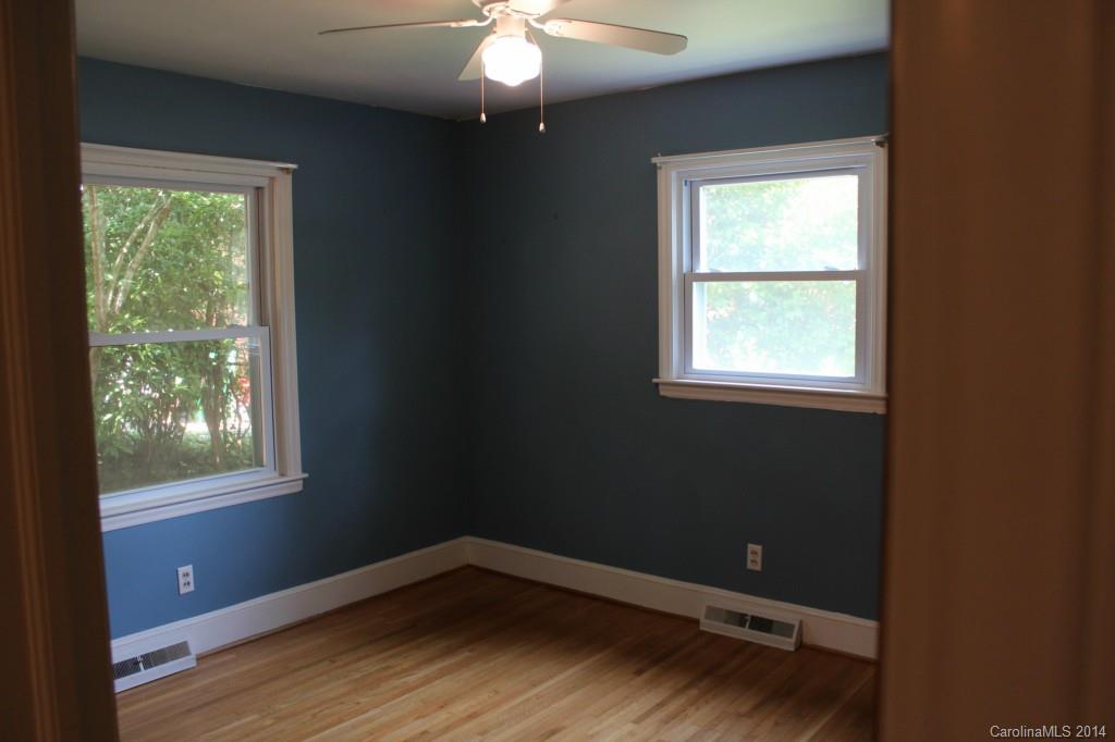 1510 Burnley Road Charlotte, NC 28210 - Photo 14 of 19 an empty room with wooden floor and windows
