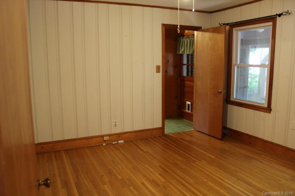 1510 Burnley Road Charlotte, NC 28210 - Photo 15 of 19 a view of an empty room with wooden floor and a window