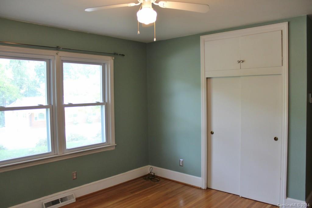 1510 Burnley Road Charlotte, NC 28210 - Photo 16 of 19 a view of an empty room with wooden floor and a window