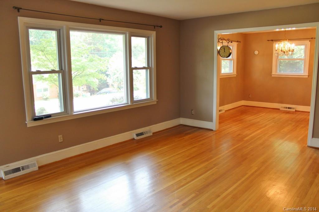 1510 Burnley Road Charlotte, NC 28210 - Photo 3 of 19 a view of an empty room with wooden floor and a window