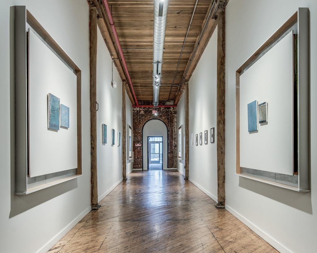 1400 Rosa L Parks Boulevard, Unit 323 Nashville, TN 37208 - Photo 3 of 25 a view of a hallway with wooden floor and staircase