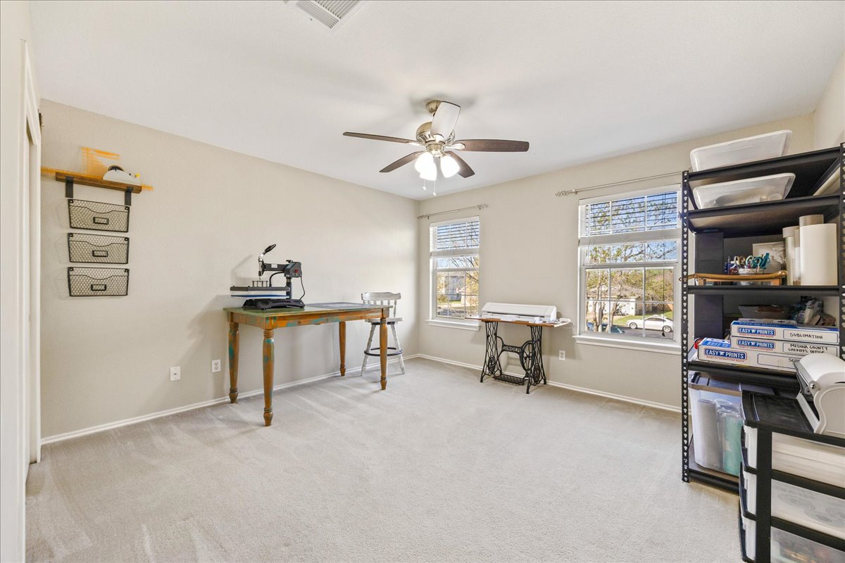 116 Devon's Cove Buda, TX 78610 - Photo 11 of 38 Office area with light colored carpet and ceiling fan
