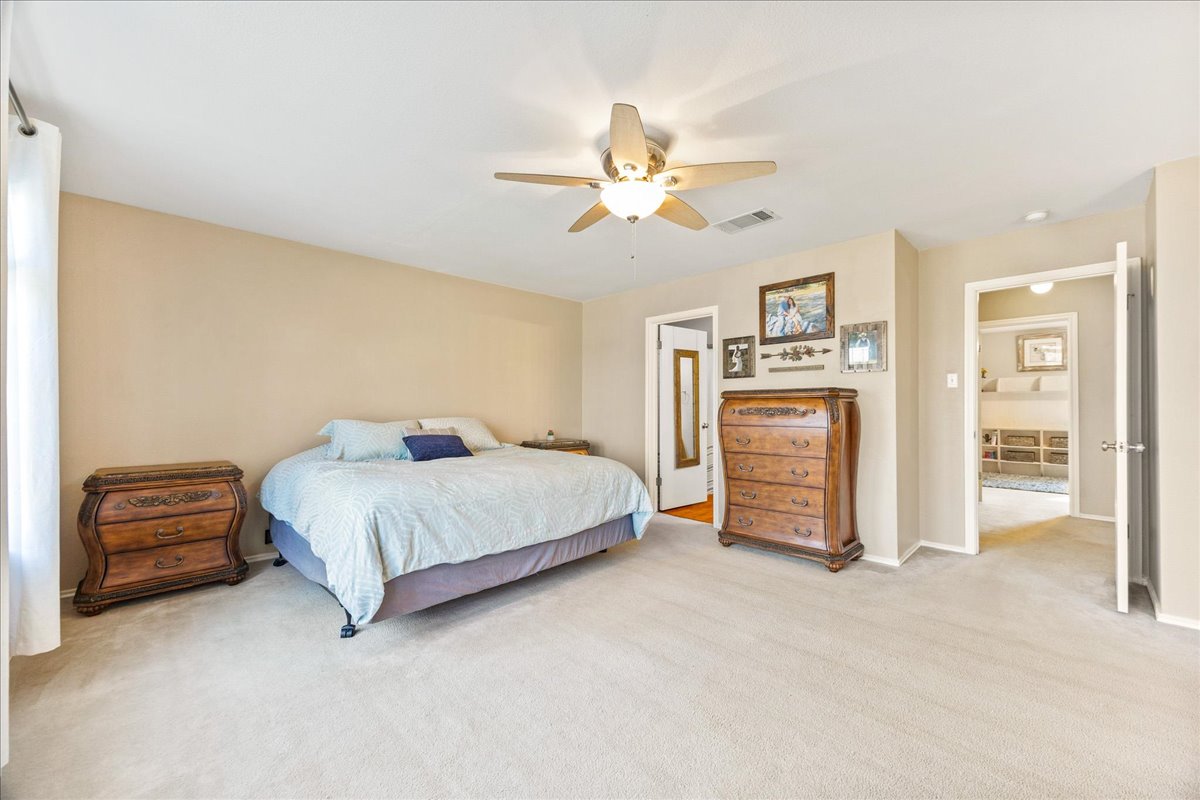 116 Devon's Cove Buda, TX 78610 - Photo 17 of 38 Bedroom featuring light carpet and ceiling fan