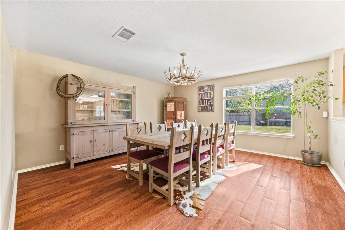116 Devon's Cove Buda, TX 78610 - Photo 28 of 38 Dining room with wood finished floors and suspended lighting