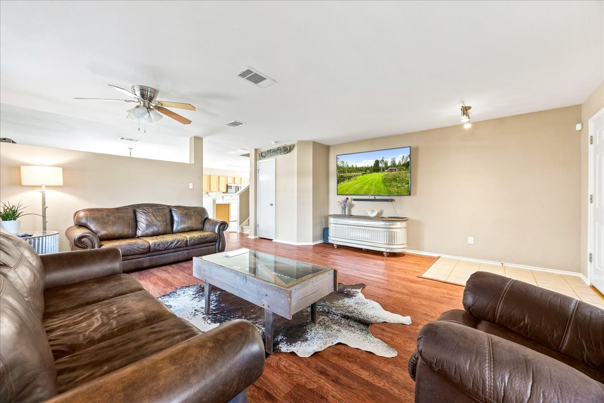 116 Devon's Cove Buda, TX 78610 - Photo 29 of 38 Living room with wood finished floors and ceiling fan