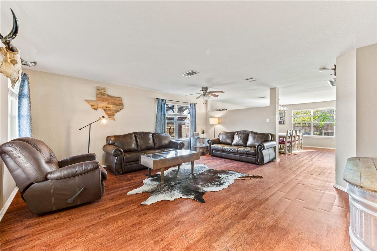 116 Devon's Cove Buda, TX 78610 - Photo 31 of 38 Living room featuring wood finished floors and ceiling fan